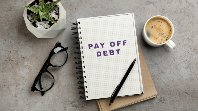 Adobe Stock - Pay off Debt on a Notebook