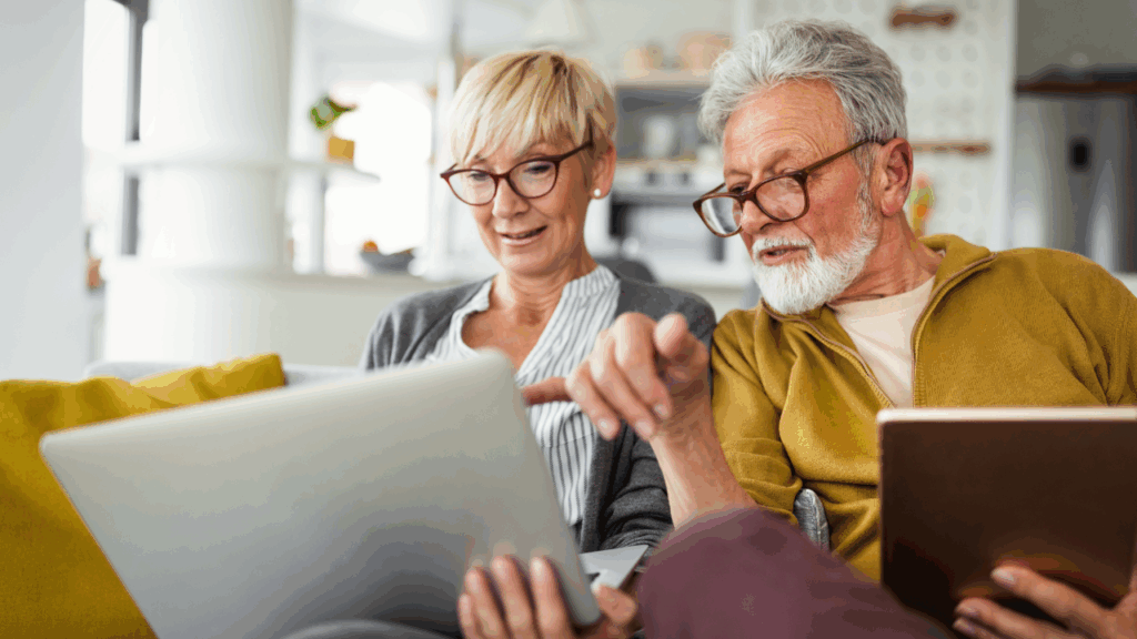 Adobe Stock - Senior couple looking at their laptops.